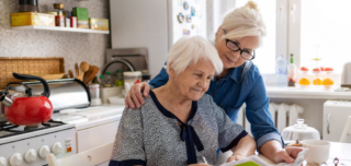 Adult_Daughter_Helps_Elderly_Woman_With_Paperwork