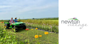 Newton Village tenants enjoy a scenic ride in a green utility vehicle at the Iowa Flower Farm, surrounded by colorful flowers and a beautiful natural landscape.