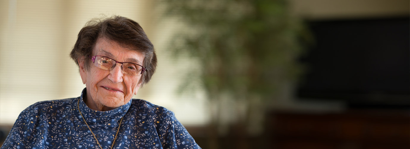 Older adult seated in a comfortable indoor setting, representing donor support and giving at Cassia
