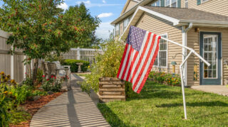 Outdoor walking path and seating area in a memory care courtyard in Newton, IA.