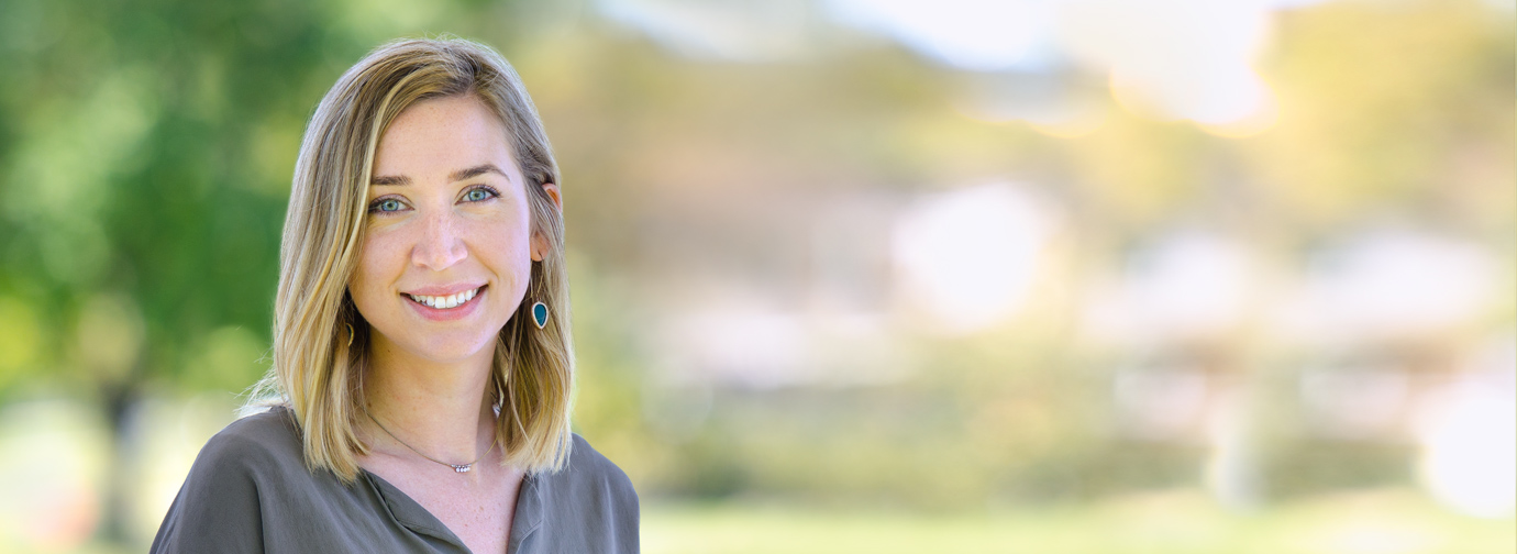 Employee portrait outdoors with a blurred natural background at Newton Village