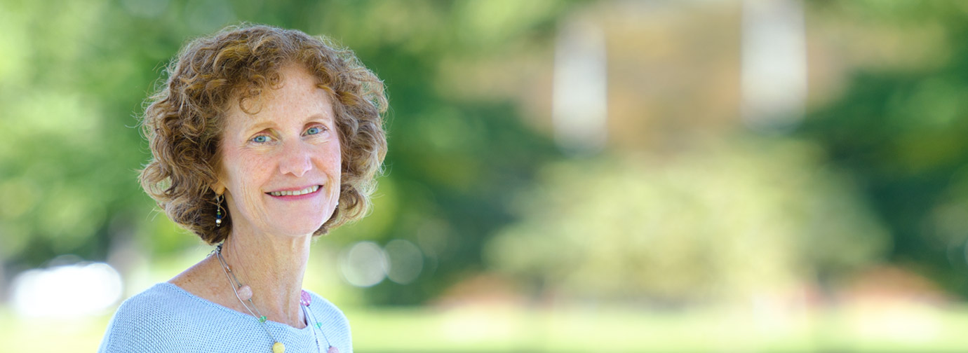 Employee portrait outdoors at Newton Village in a landscaped setting
